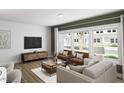 Bright living room with large windows, modern furniture, hardwood floors and recessed lighting at 815 Central Park Dr, Knightdale, NC 27604