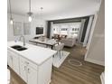 Open-concept living space with dining area, kitchen island, and modern living room at 815 Central Park Dr, Knightdale, NC 27604