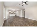 Open-concept living area with hardwood floors and seamless transition to the modern kitchen and dining space at 303 E Pope Ave, Kenly, NC 27542
