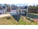 Stylish single-Gathering home featuring a two-car garage, and attractive landscaping at 32 Bonnybrook Ct, Selma, NC 27576