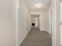 Inviting hallway with durable gray flooring leading to a bright and open living area at 32 Bonnybrook Ct, Selma, NC 27576
