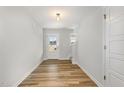 Bright entryway featuring wood-look floors, a white door with glass, and a staircase at 33 W Emily Gardens Dr, Selma, NC 27576