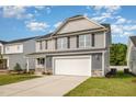 Two-story home with neutral siding, black shutters, and an attached two-car garage at 33 W Emily Gardens Dr, Selma, NC 27576