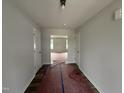 Bright hallway with wood floors and neutral paint, leading to a spacious living area at 33 W Emily Gardens Dr, Selma, NC 27576