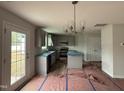 Modern kitchen featuring gray cabinets, stainless steel appliances, and a stylish chandelier above island at 33 W Emily Gardens Dr, Selma, NC 27576