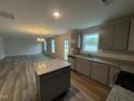 Kitchen with gray cabinets, granite countertops, stainless steel appliances and an island at 33 W Emily Gardens Dr, Selma, NC 27576