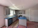 New kitchen featuring gray cabinets, an island, and stainless steel appliances at 33 W Emily Gardens Dr, Selma, NC 27576