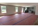 Spacious, light-filled open-concept living room and kitchen area with large windows at 33 W Emily Gardens Dr, Selma, NC 27576
