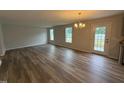Open-concept living room and kitchen with hardwood floors and modern lighting at 33 W Emily Gardens Dr, Selma, NC 27576