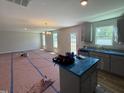 Open floor plan with views of the kitchen featuring stainless steel appliances and an island with cabinets at 33 W Emily Gardens Dr, Selma, NC 27576