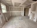 Unfinished living room with drywall, one window, light fixtures and an open doorway providing natural light and access at 33 W Emily Gardens Dr, Selma, NC 27576
