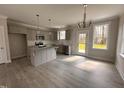 Modern kitchen with gray cabinets, granite countertops, stainless steel appliances, and wood-look flooring at 39 N Rowsham Pl, Smithfield, NC 27577