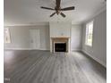 Bright living room featuring wood-look floors, fireplace, and a ceiling fan with recessed lighting at 39 N Rowsham Pl, Smithfield, NC 27577