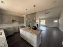 Modern kitchen featuring an island with pendant lighting, grey cabinets and stainless appliances at 40 Bailey-Boykin Rd, Selma, NC 27576