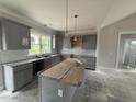 Elegant gray kitchen with granite countertops, central island, and stylish pendant lighting offering modern appeal at 40 Bailey-Boykin Rd, Selma, NC 27576