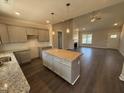 Open-concept kitchen showcasing a center island, modern cabinets, granite countertops, and stylish pendant lighting at 40 Bailey-Boykin Rd, Selma, NC 27576