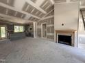 Bright living room featuring a fireplace, high ceilings, and open layout to the kitchen at 40 Bailey-Boykin Rd, Selma, NC 27576