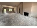 Spacious living room with fireplace and large windows for natural light at 40 Bailey-Boykin Rd, Selma, NC 27576