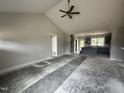Open-concept living space with high ceilings and seamlessly connected kitchen area for modern living and entertaining at 40 Bailey-Boykin Rd, Selma, NC 27576