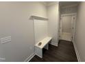 Functional mudroom with built-in bench, shiplap, and convenient access to other areas of the home at 40 Bailey-Boykin Rd, Selma, NC 27576