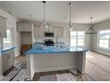 Modern kitchen featuring stainless steel appliances, a center island, pendant lighting, and bright windows at 40 Tuskeegee Dr, Smithfield, NC 27577