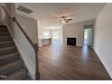 Spacious open-concept living room featuring a fireplace, wood floors, and a staircase leading to the upper level at 40 Tuskeegee Dr, Smithfield, NC 27577