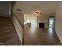 Bright, open-concept living space with modern flooring, fireplace, and staircase leading upstairs at 40 Tuskeegee Dr, Smithfield, NC 27577