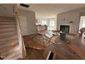 Spacious living room featuring a fireplace and staircase, awaiting finishing touches at 40 Tuskeegee Dr, Smithfield, NC 27577