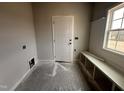 Well-lit mudroom area with storage bench, white door and window ready for personalization at 40 Tuskeegee Dr, Smithfield, NC 27577