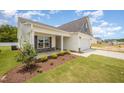 Beautiful house exterior showcasing a covered front porch and a two-car garage at 41 W Emily Gardens Dr, Selma, NC 27576