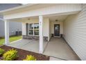 Welcoming covered front porch with stone accents and a stylish front door at 41 W Emily Gardens Dr, Selma, NC 27576