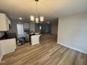 Bright kitchen with granite countertops, a center island with hardwood floors in an open floor plan at 41 W Emily Gardens Dr, Selma, NC 27576