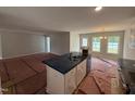 Stylish kitchen featuring a center island with sink, pendant lights, and sleek appliances at 41 W Emily Gardens Dr, Selma, NC 27576