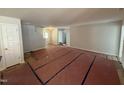 Spacious open-concept living room with neutral walls and modern staircase at 41 W Emily Gardens Dr, Selma, NC 27576
