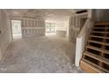 Spacious living room area featuring an open layout and ample natural light with unfinished elements at 41 W Emily Gardens Dr, Selma, NC 27576