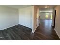 Open entryway with hardwood floors leading to a bright living space with neutral paint at 43 Chloe Ct, Selma, NC 27576