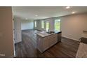 Modern kitchen island with stainless steel appliances, granite countertops, and ample cabinet space at 43 Chloe Ct, Selma, NC 27576