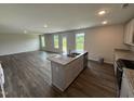 Kitchen with island featuring granite countertop, stainless sink, and ample room to entertain and enjoy the scenery at 43 Chloe Ct, Selma, NC 27576