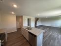 A kitchen island with a stainless steel sink, dishwasher, and granite countertops at 43 Chloe Ct, Selma, NC 27576