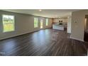 Spacious living room with hardwood floors, natural light, and an open kitchen at 43 Chloe Ct, Selma, NC 27576