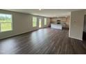 Open concept living area features wood floor, plenty of light, and an eat-in kitchen with granite countertops at 43 Chloe Ct, Selma, NC 27576