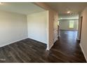 A bright living room features hardwood floors and lots of natural light from the windows at 43 Chloe Ct, Selma, NC 27576