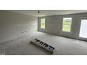 A bright, spacious bedroom with two windows offering natural light and exterior views, ready for personalization at 43 Chloe Ct, Selma, NC 27577