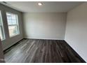Bright bedroom with hardwood floors and large windows offering plenty of natural light at 43 Chloe Ct, Selma, NC 27576