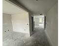 Hallway with neutral paint, leading to other rooms in the home, with natural light streaming in through the windows at 43 Chloe Ct, Selma, NC 27577