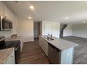 Kitchen featuring granite countertops, an island with a sink, and stainless steel appliances at 43 Chloe Ct, Selma, NC 27577