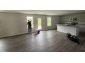 Open living room features hardwood floors, granite countertops, and stainless sink at 43 Chloe Ct, Selma, NC 27577
