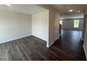 A spacious living room with dark wood-look flooring and natural light at 43 Chloe Ct, Selma, NC 27577