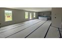 Spacious living room and kitchen area featuring three large windows and a center island at 43 Chloe Ct, Selma, NC 27577