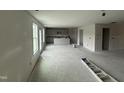 A spacious living room with ample natural light, seamlessly connected to the kitchen area at 43 Chloe Ct, Selma, NC 27577